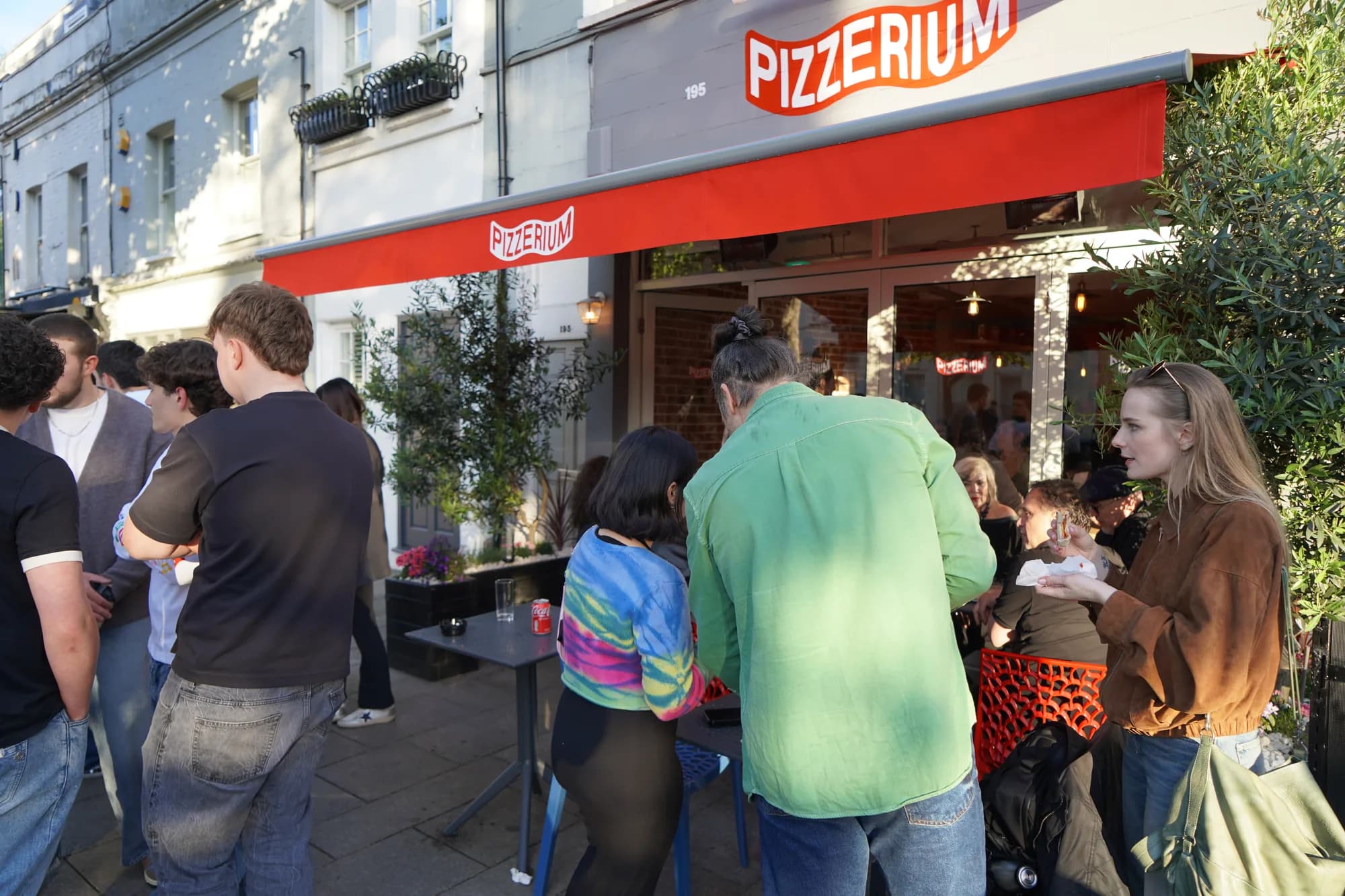 Pizzerium Battersea storefront, 195 St John's Hill, with the bold red Pizzerium awning